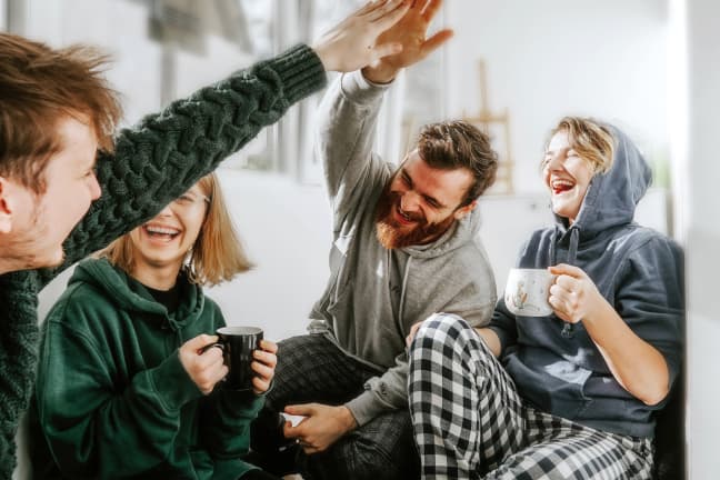 Group of laughing people high-fiving